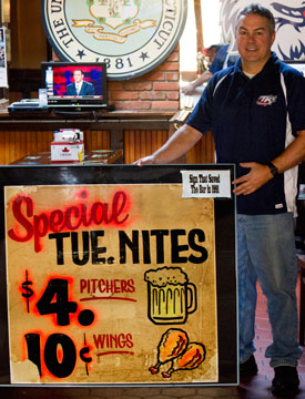 Tom 'TK' Kennedy with the sign that saved the bar in 1991